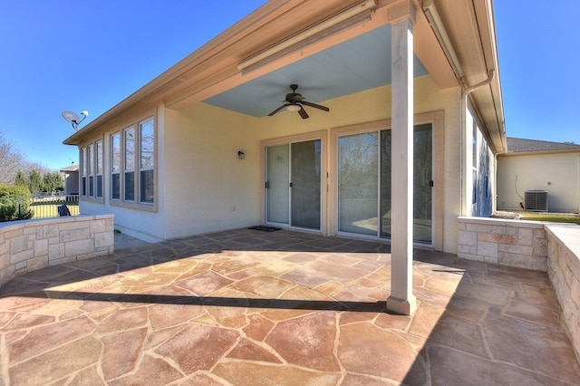 view of patio with ceiling fan and central AC