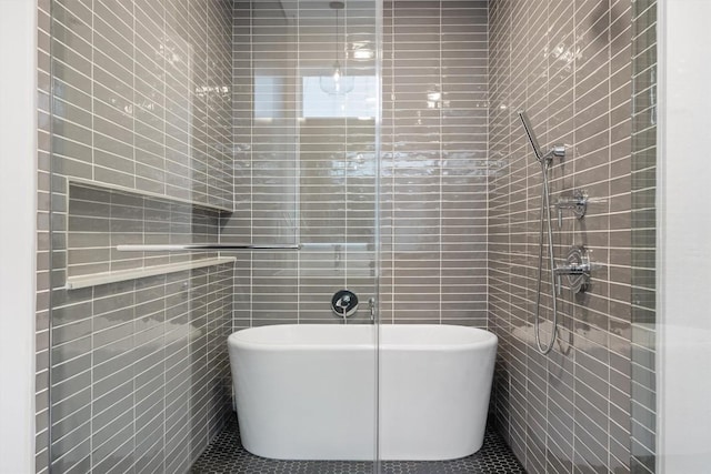 3100 Menchaca Rd Unit 29, Austin, TX 78704 - full bath featuring tile walls, a freestanding tub, tile patterned flooring, and a tile shower