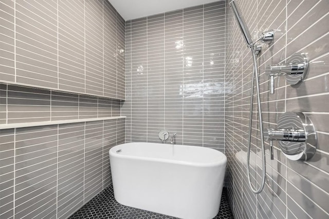 3100 Menchaca Rd Unit 29, Austin, TX 78704 - bathroom with tile walls, a freestanding bath, tile patterned flooring, and a tile shower