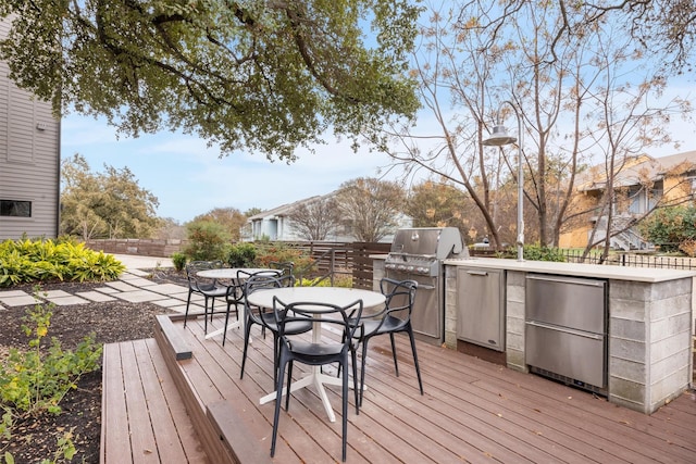 wooden deck featuring an outdoor kitchen and area for grilling