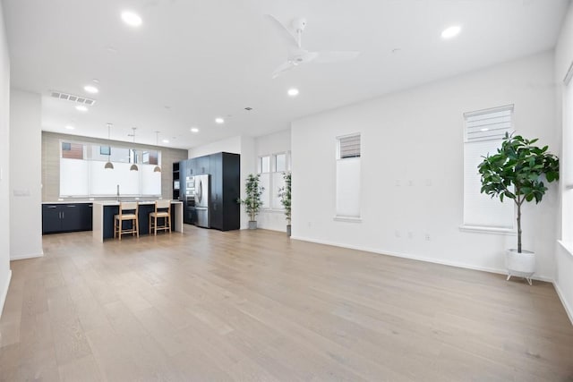 3100 Menchaca Rd Unit 29, Austin, TX 78704 - unfurnished living room featuring recessed lighting, light wood-style floors, healthy amount of natural light, and ceiling fan