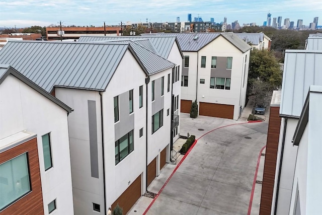 3100 Menchaca Rd Unit 29, Austin, TX 78704 - view of front of home with a standing seam roof, stucco siding, a skyline view, a metal roof, and concrete driveway