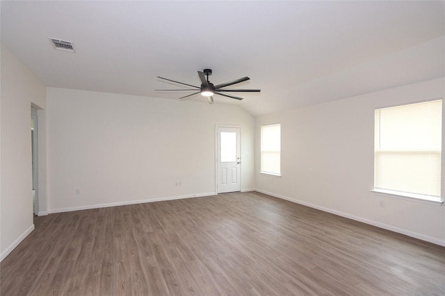 spare room featuring vaulted ceiling, ceiling fan, and dark hardwood / wood-style flooring