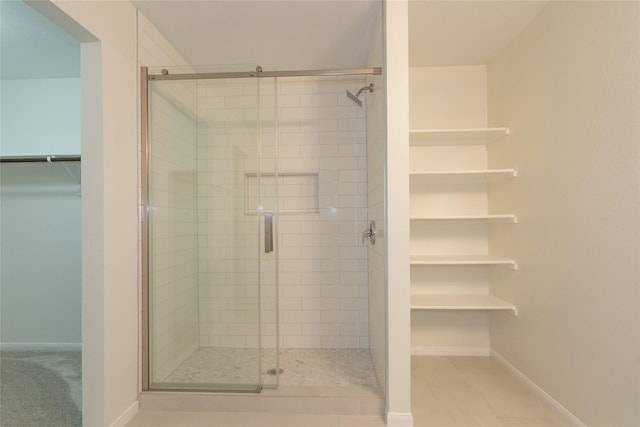 bathroom with a shower with door