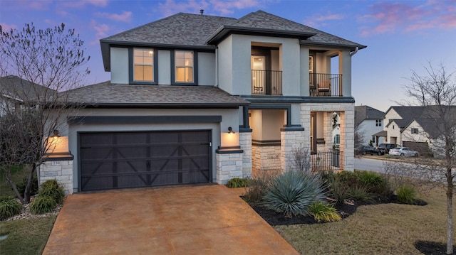 view of front of property with a balcony and a garage