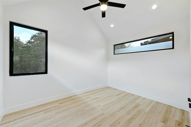 spare room featuring ceiling fan, high vaulted ceiling, and light wood-type flooring