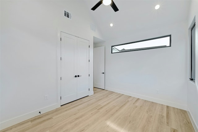 spare room featuring ceiling fan, high vaulted ceiling, and light hardwood / wood-style flooring