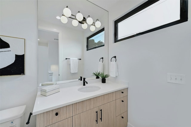 bathroom featuring vanity and toilet