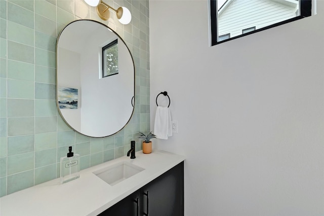 bathroom with vanity and decorative backsplash