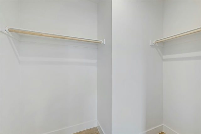 spacious closet featuring hardwood / wood-style floors