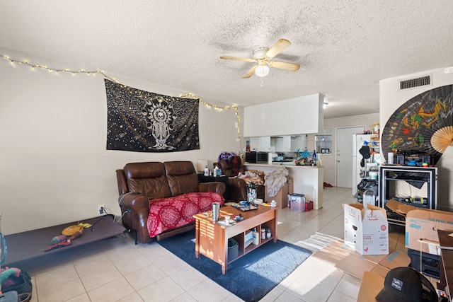 tiled living room with a textured ceiling and ceiling fan