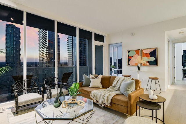 living room with light wood-type flooring and floor to ceiling windows