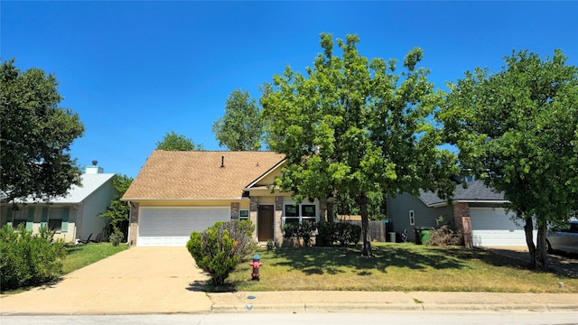 view of front of property with a front yard and a garage