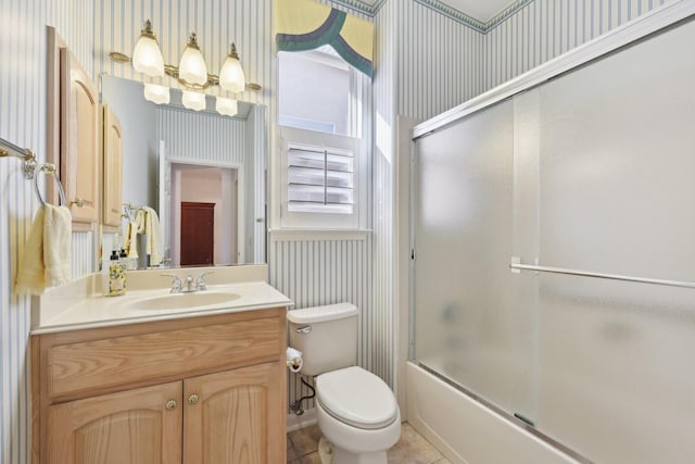 full bathroom with vanity, tile patterned flooring, toilet, and combined bath / shower with glass door