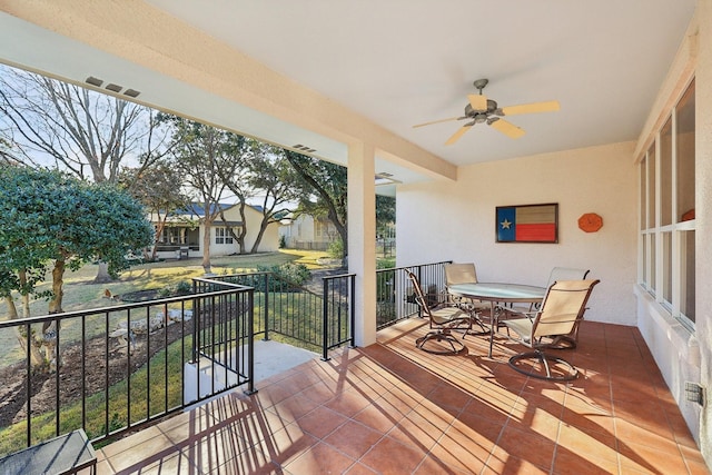 balcony with ceiling fan and a porch