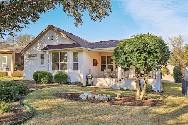 ranch-style house featuring a sunroom and a front yard