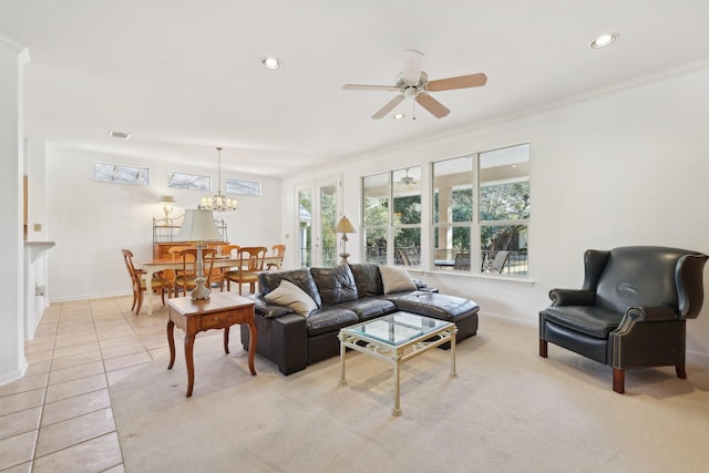 tiled living room featuring ceiling fan with notable chandelier and ornamental molding