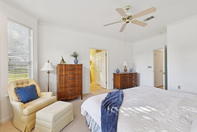 bedroom featuring light carpet, crown molding, ceiling fan, and ensuite bathroom