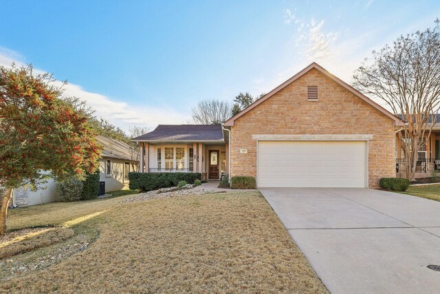 ranch-style home featuring a garage, a front lawn, and covered porch