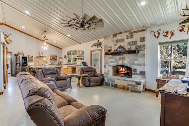 living room with a fireplace, ceiling fan, and a towering ceiling