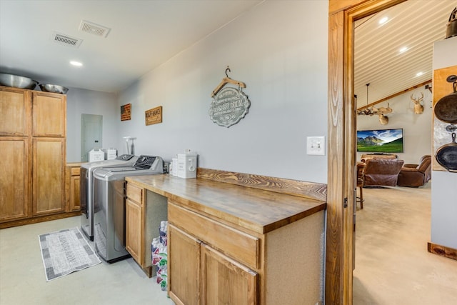 laundry room featuring cabinets and washer and clothes dryer