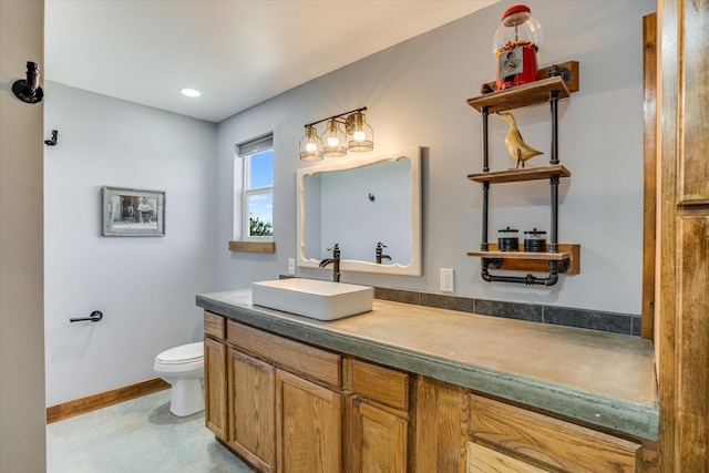 bathroom with toilet and vanity