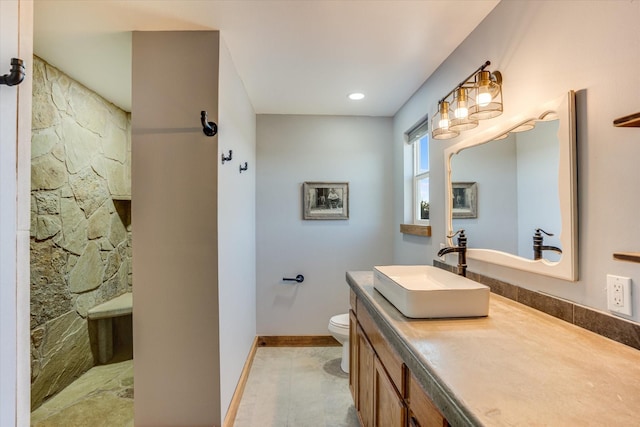 bathroom with toilet, a shower, and vanity