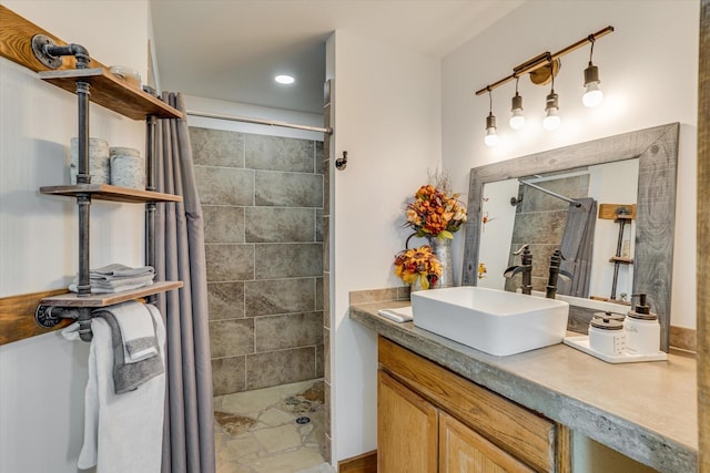 bathroom featuring walk in shower and vanity