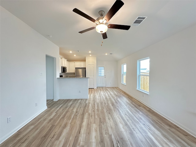 unfurnished living room with ceiling fan and light hardwood / wood-style floors