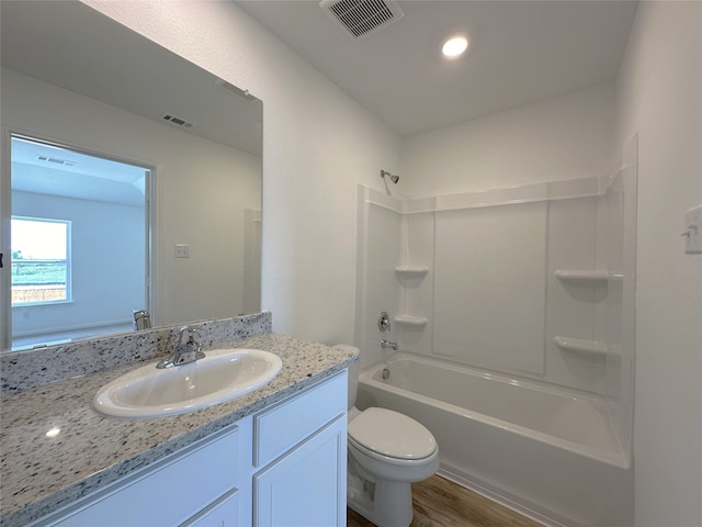 full bathroom with toilet, shower / bathtub combination, wood-type flooring, and vanity