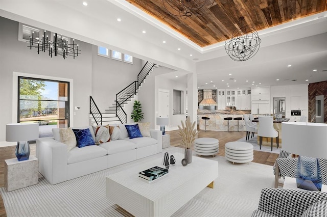 living room with wooden ceiling, a chandelier, and a tray ceiling