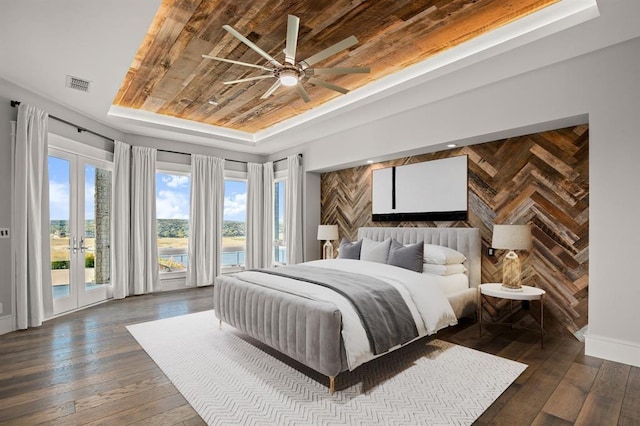 bedroom with ceiling fan, access to outside, a tray ceiling, wood ceiling, and french doors