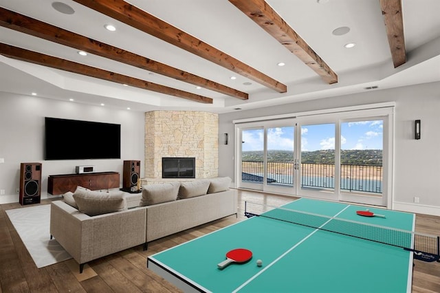 playroom featuring hardwood / wood-style floors and a stone fireplace