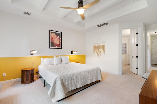 bedroom featuring ceiling fan, beam ceiling, and light carpet