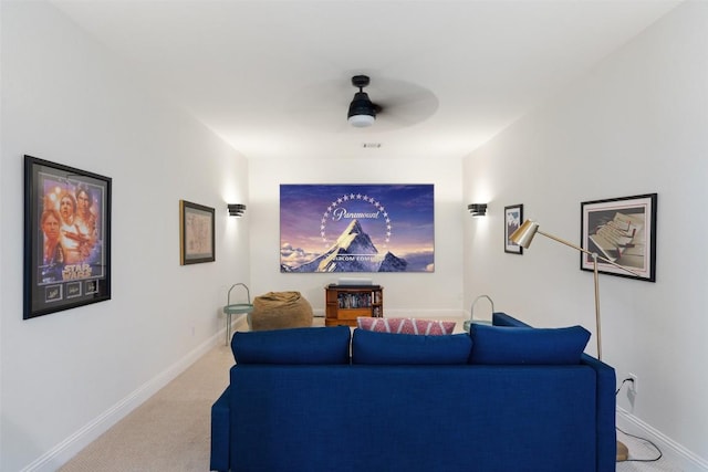 carpeted home theater with baseboards and ceiling fan