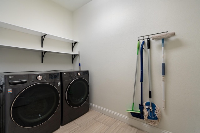 clothes washing area with washer and clothes dryer