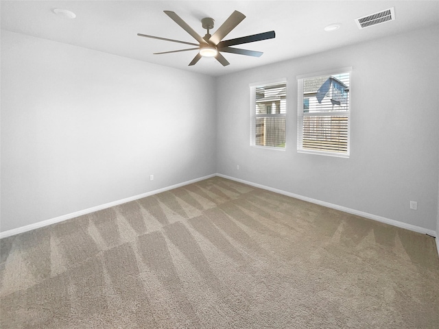 carpeted spare room with ceiling fan