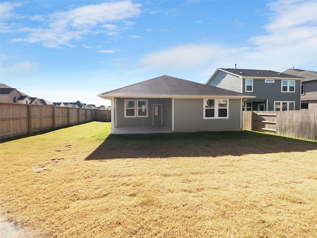 back of house featuring a patio area and a yard