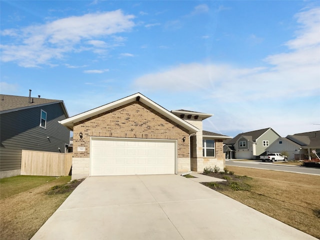 view of front of property featuring a garage and a front lawn