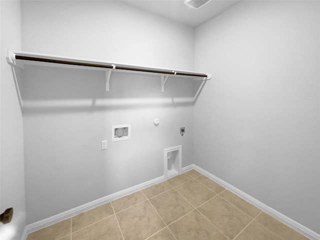 laundry area featuring light tile patterned flooring, hookup for an electric dryer, hookup for a washing machine, and hookup for a gas dryer