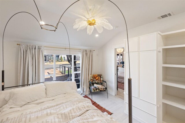 bedroom with vaulted ceiling and light hardwood / wood-style flooring