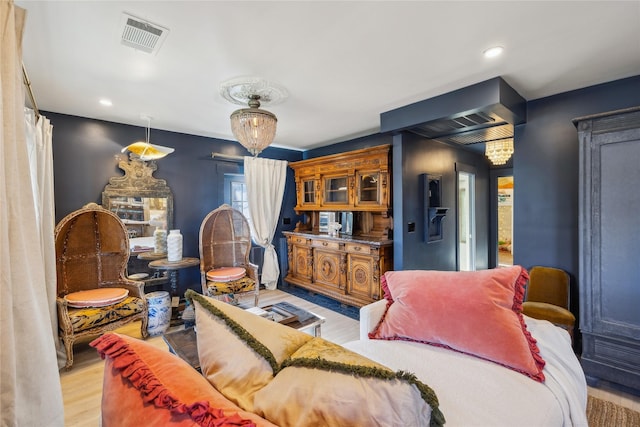 living room with a chandelier and light hardwood / wood-style floors