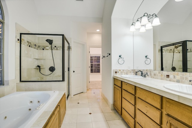 bathroom featuring backsplash, vanity, independent shower and bath, and tile patterned flooring