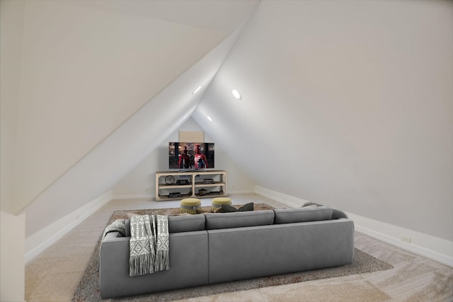 living room featuring carpet and vaulted ceiling