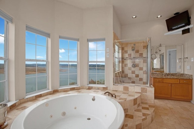 2918 Ranch Road 620 N Unit L-177, Austin, TX 78734 - bathroom with vanity, a jetted tub, a stall shower, recessed lighting, and a water view