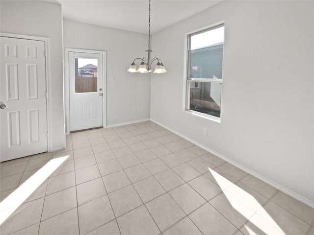 109 Morning Quail Dr, Jarrell, TX 76537 - unfurnished dining area featuring healthy amount of natural light, a chandelier, light tile patterned flooring, and baseboards