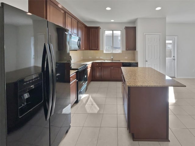 109 Morning Quail Dr, Jarrell, TX 76537 - kitchen with fridge with ice dispenser, black range with electric cooktop, stainless steel microwave, a sink, and decorative backsplash