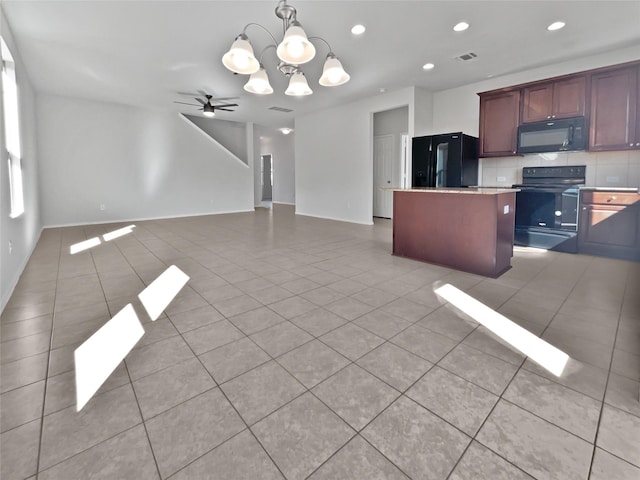 kitchen featuring tasteful backsplash, a center island, black appliances, light tile patterned floors, and ceiling fan with notable chandelier