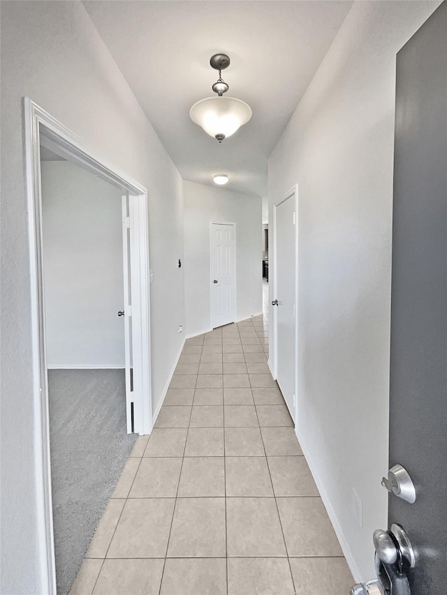 hall with light tile patterned flooring