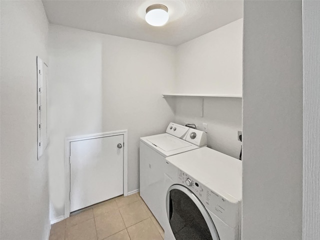 washroom with washer and dryer and light tile patterned flooring